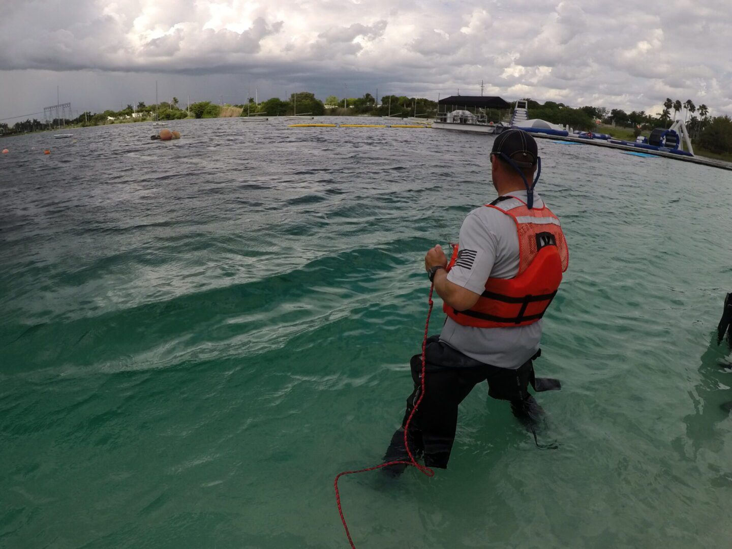 A man in the water with a life vest on.