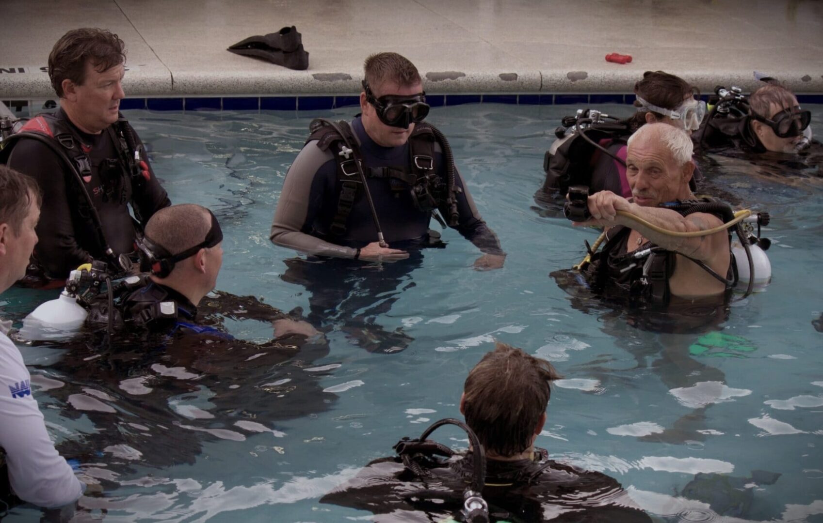 A group of people in the water with scuba gear.