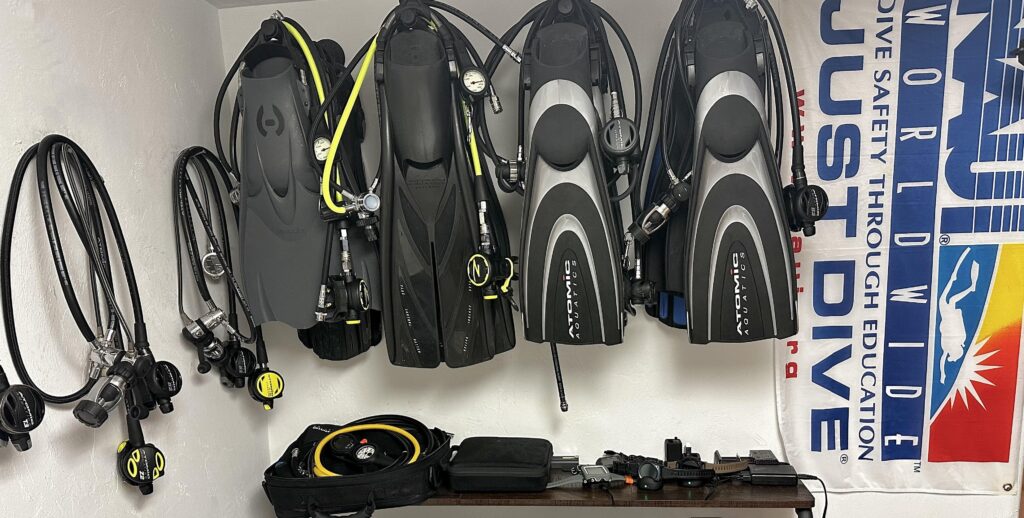 All the scuba diving equipments hung on the wall.