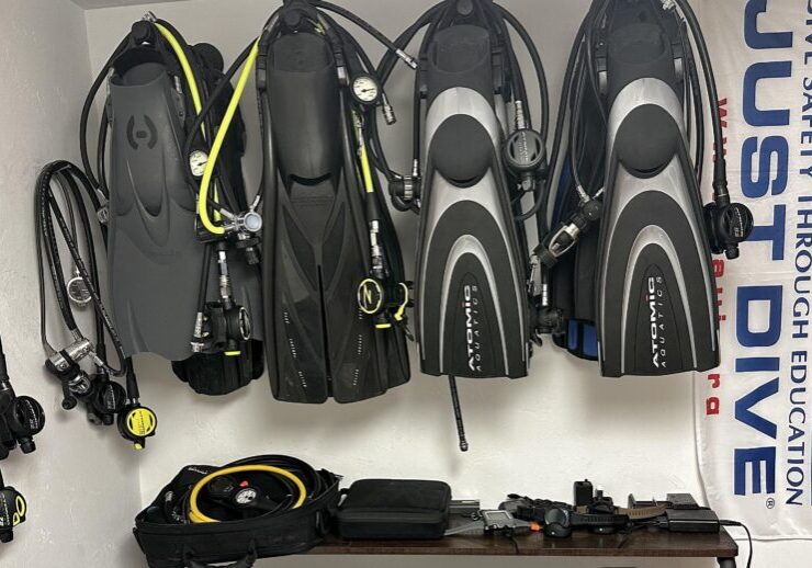 All the scuba diving equipments hung on the wall.